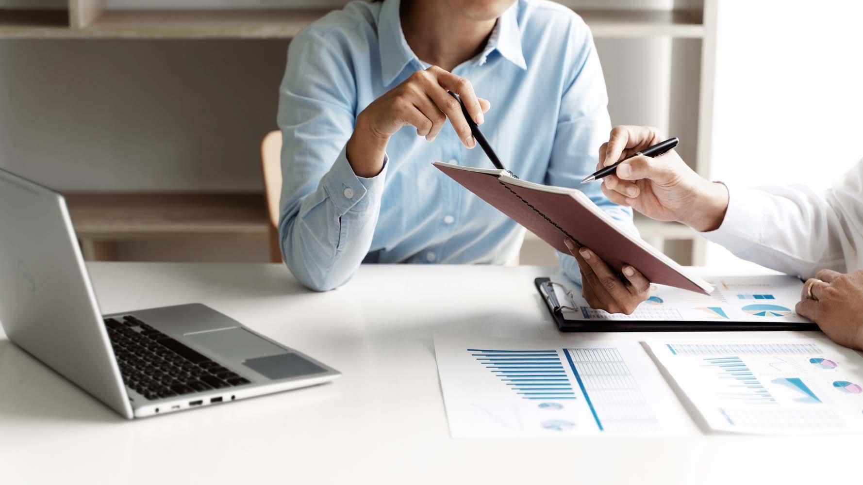 Professionals review documents and figures