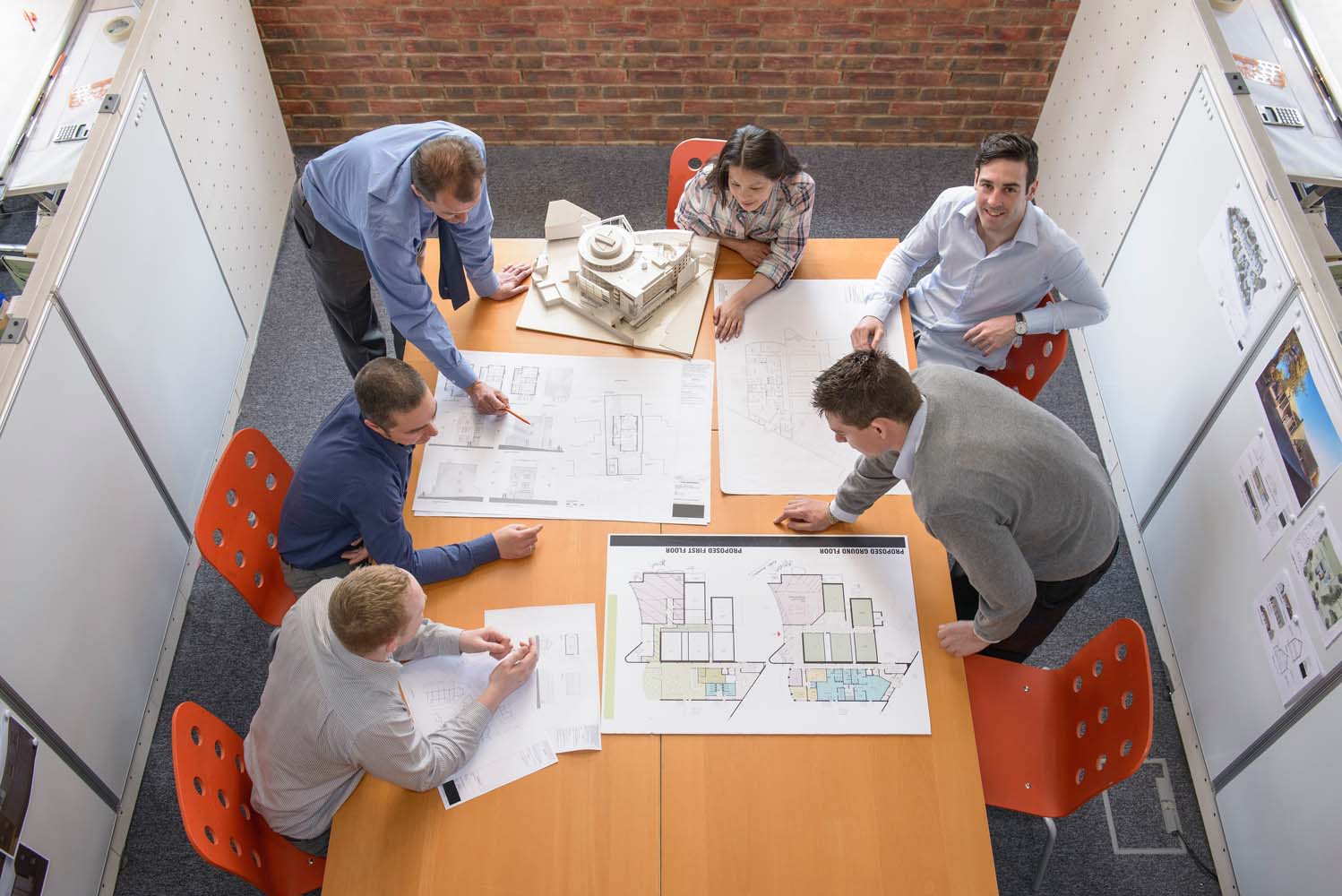 Group of architects and engineers looks over documents